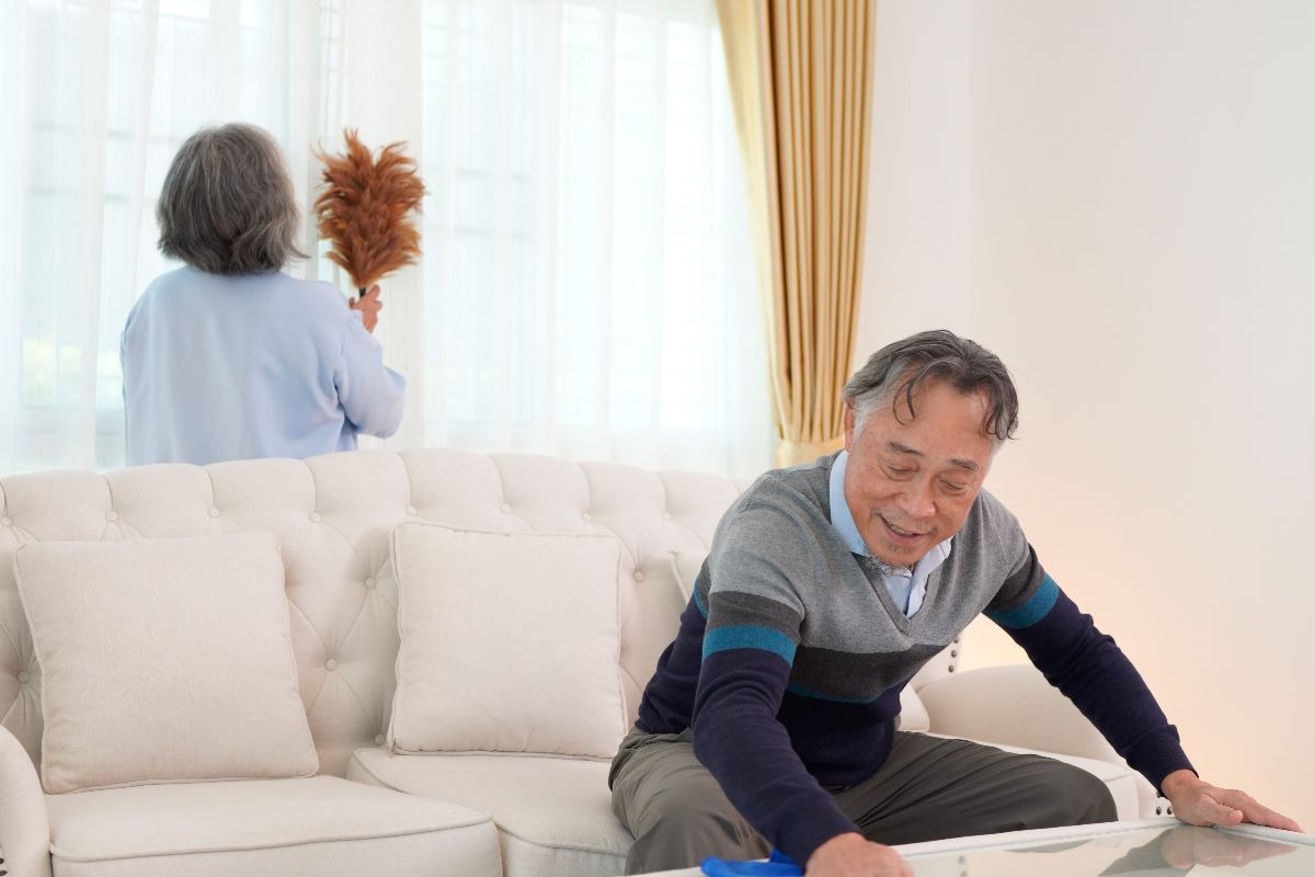 Elderly couple cleaning as part of their daily routine at home