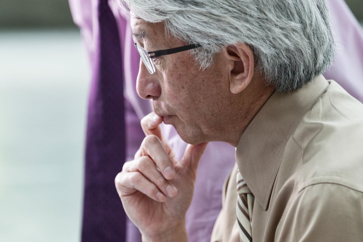 An older Asian businessman involved in a business meeting
